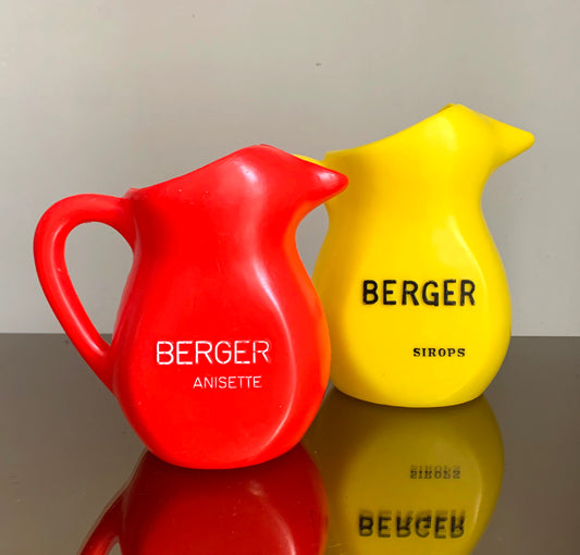 A Pair of Vintage French Berger Anisette & Sirops Red & Yellow Plastic Jugs