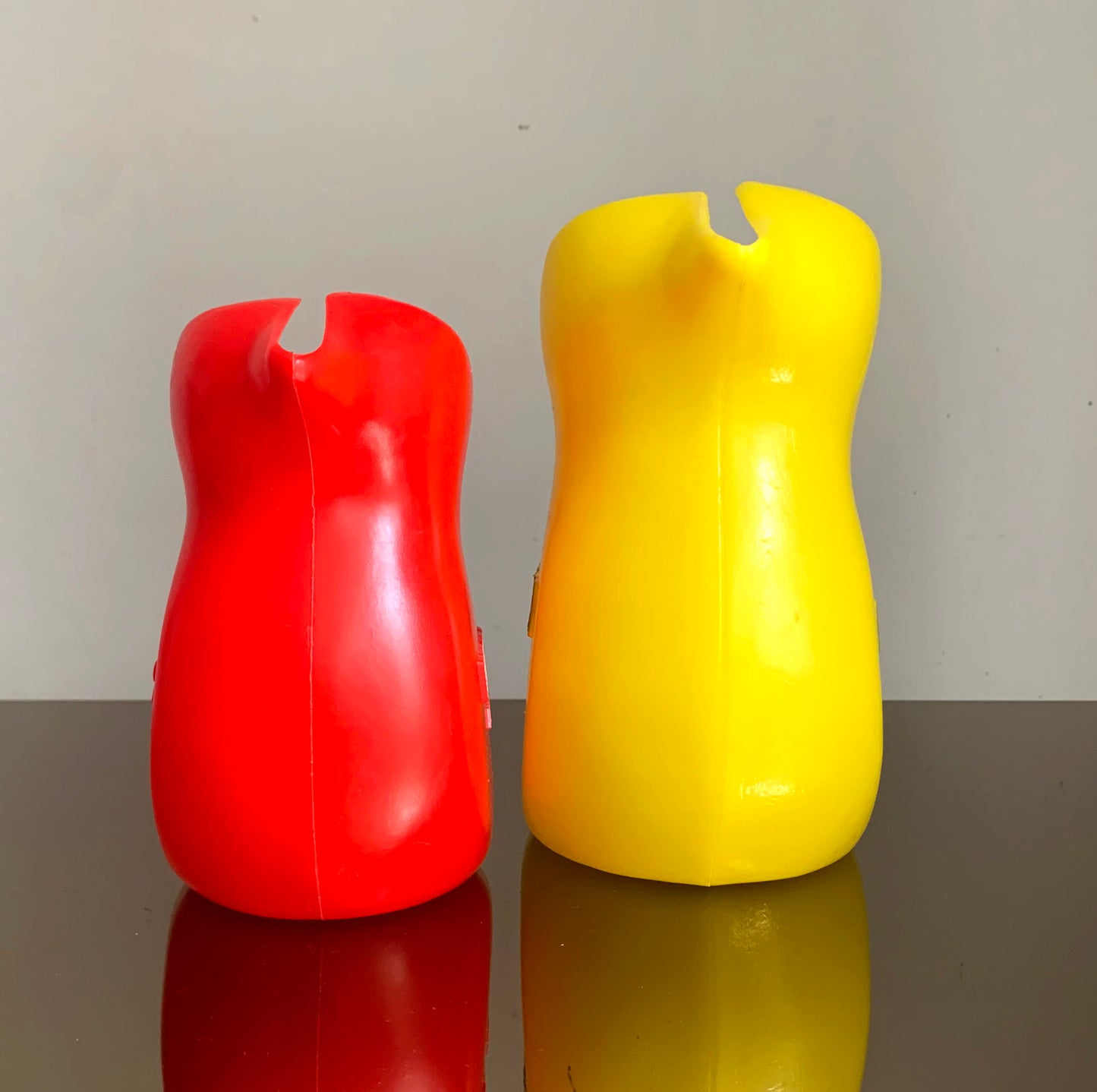 A Pair of Vintage French Berger Anisette & Sirops Red & Yellow Plastic Jugs