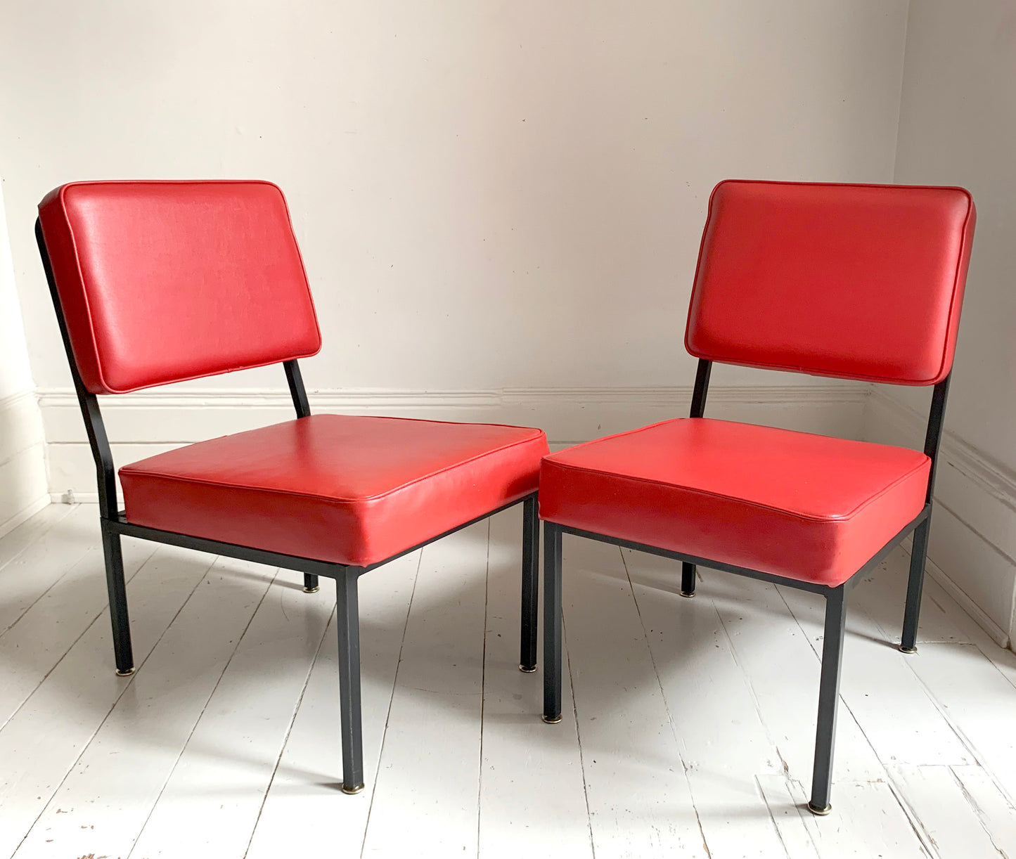 Mid Century Pair of Red Vinyl Lounge Chairs With Brass Feet