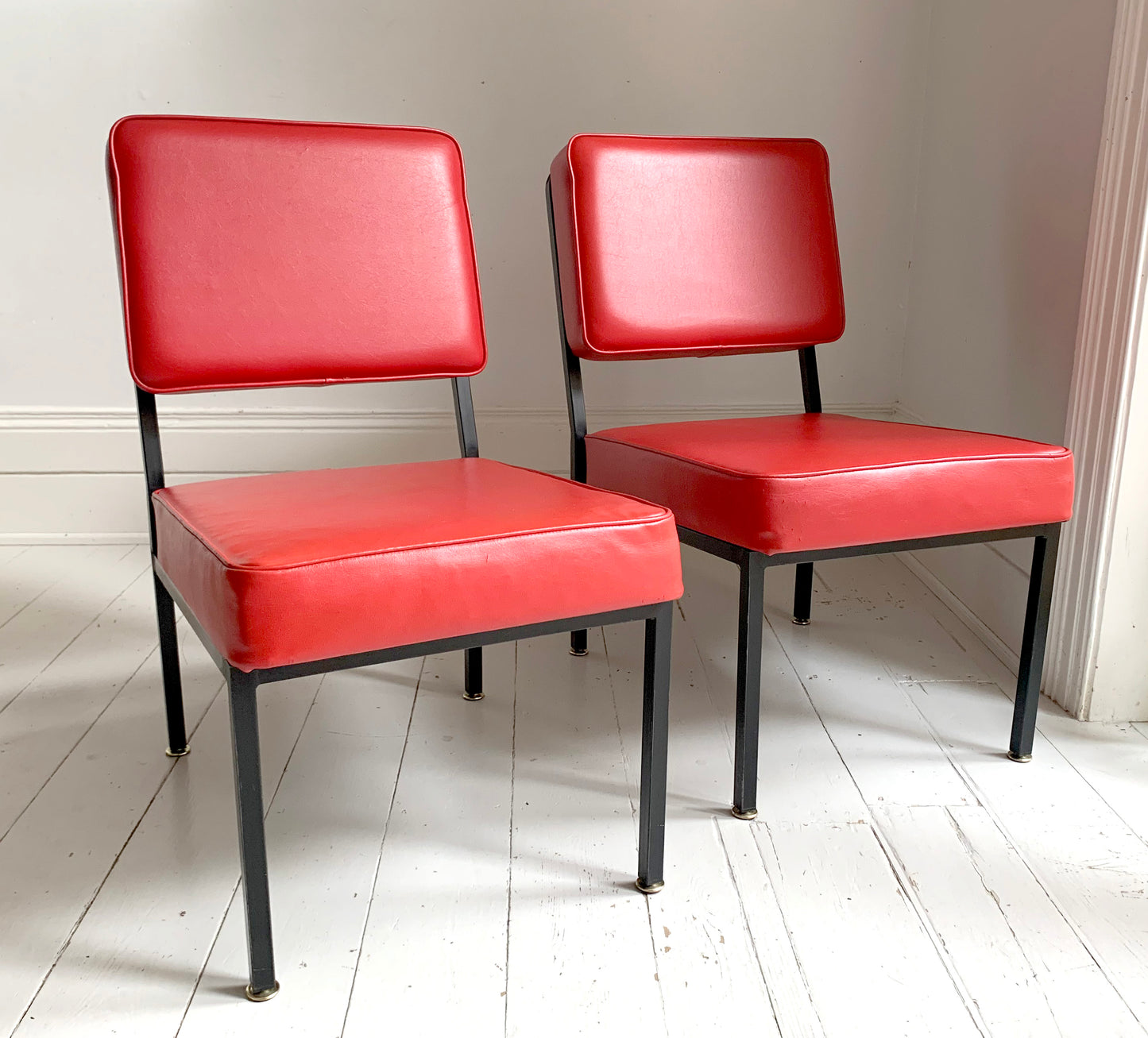 Mid Century Pair of Red Vinyl Lounge Chairs With Brass Feet