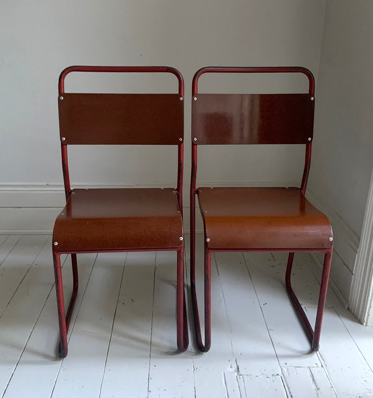 Vintage Cox Stacking Chairs; A Pair Tubular Steel Chairs with Rich Red Patina