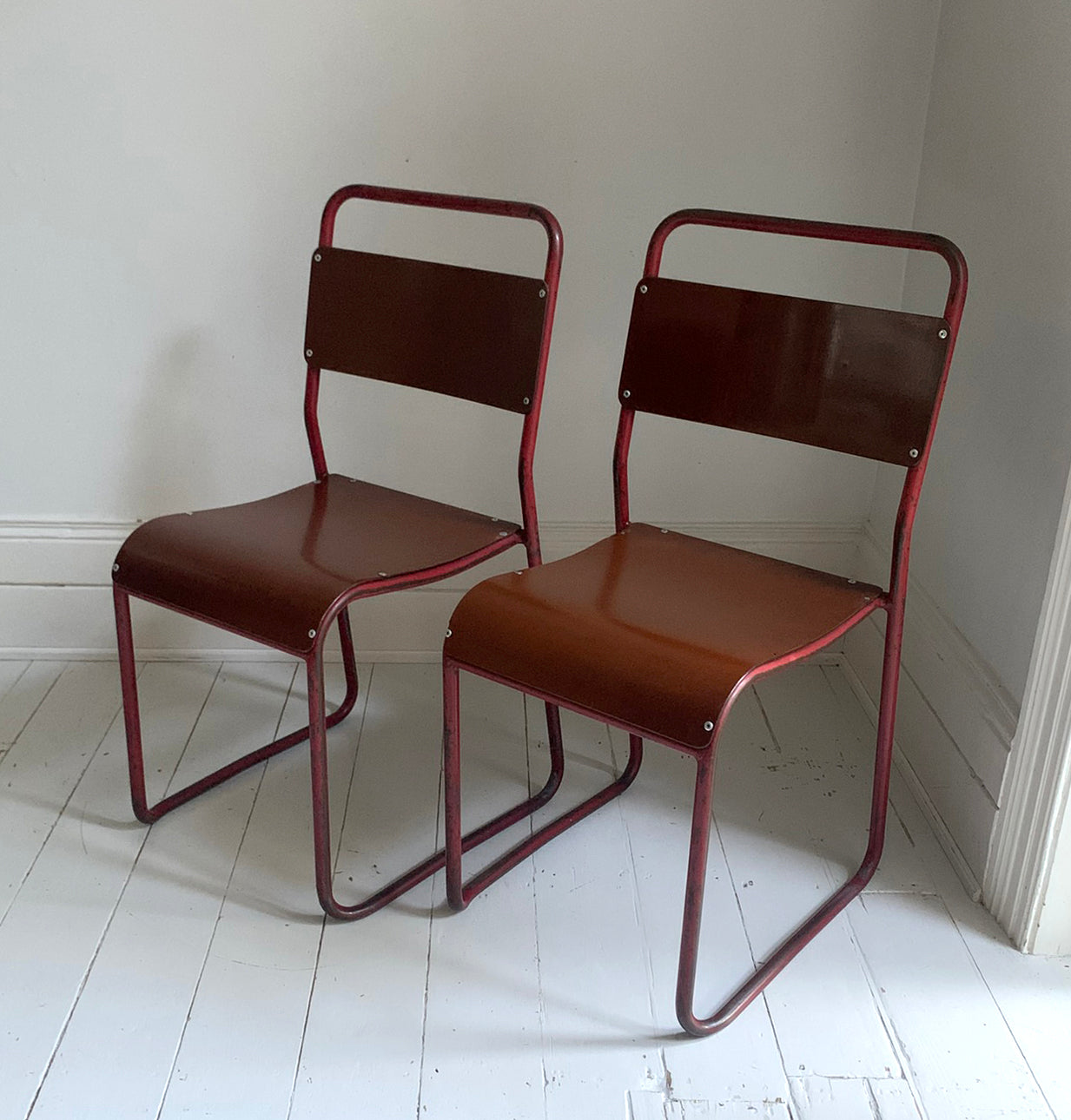 Vintage Cox Stacking Chairs; A Pair Tubular Steel Chairs with Rich Red Patina