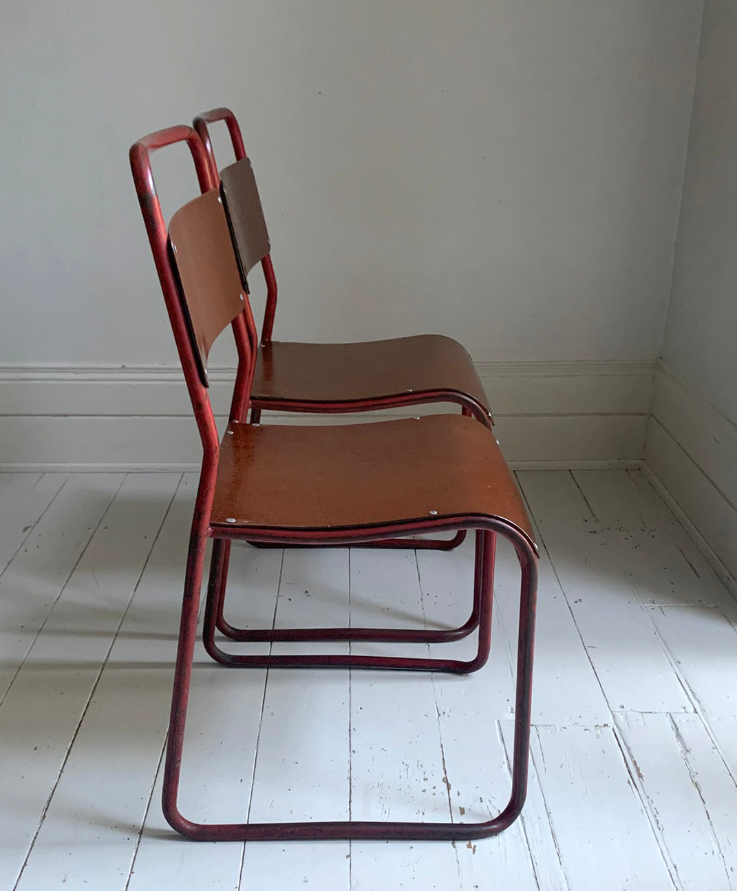 Vintage Cox Stacking Chairs; A Pair Tubular Steel Chairs with Rich Red Patina